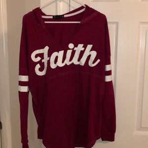 Long sleeve shirt with faith across the front.